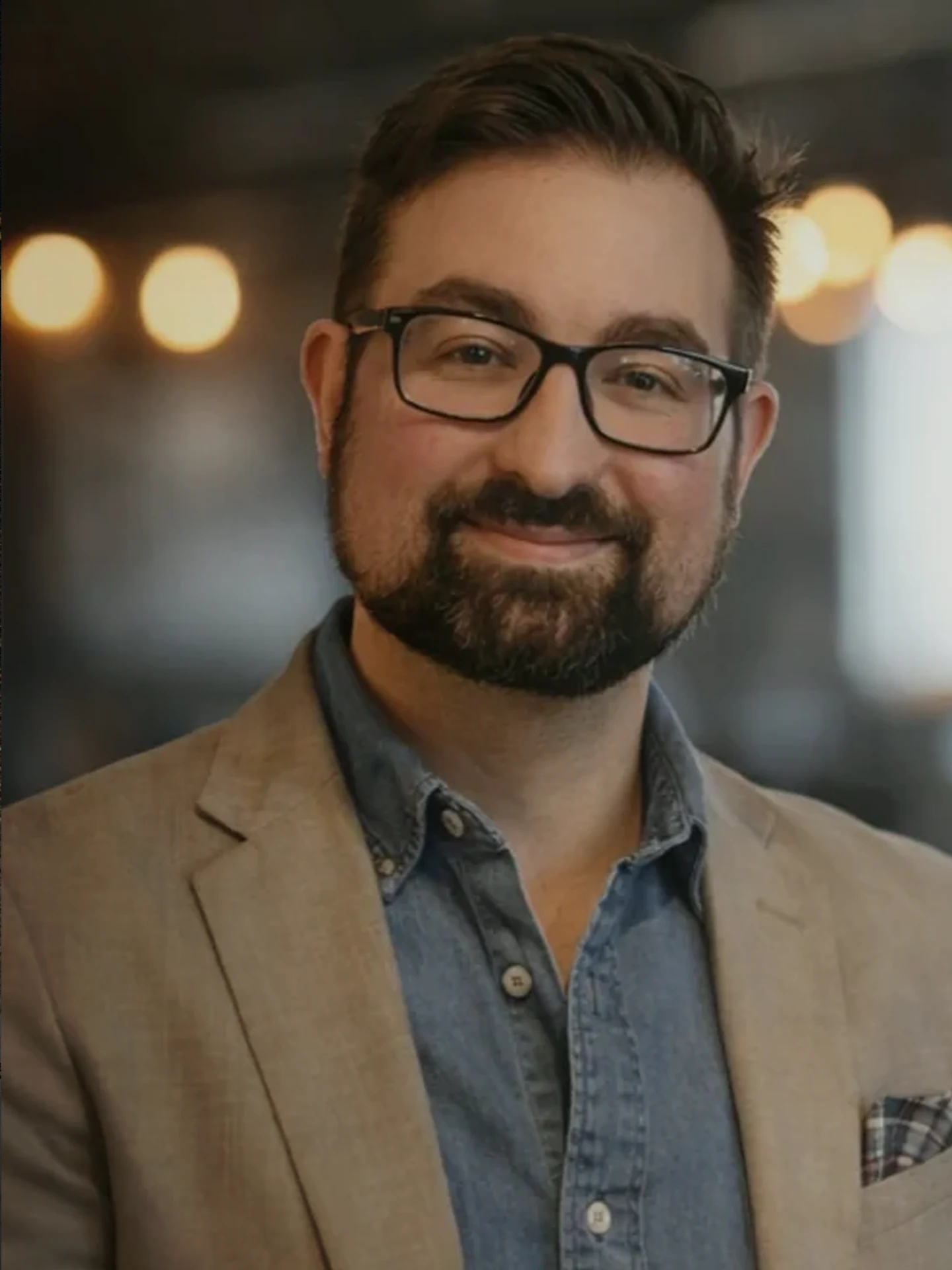 Brian Bachman, MA, LPC, wearing a tan blazer