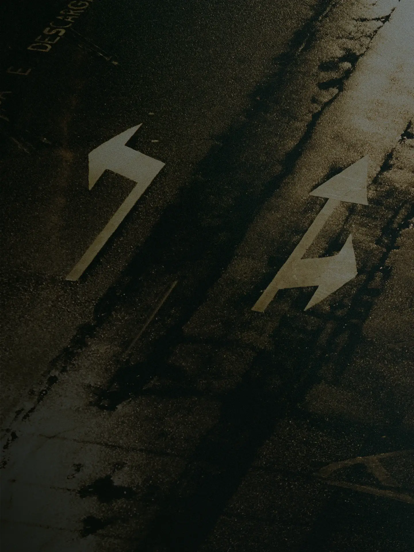 Yellow directional arrow painted on pavement